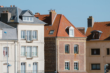 Fototapeta na wymiar Facades of traditional residential houses with mansard stores in Dieppe, Normandy region, France. Norman style old houses. Beautiful european cityscape with typical french architecture