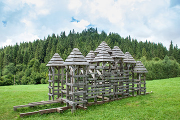 Wooden fortress towers, reconstruction of old battles, forest lawn