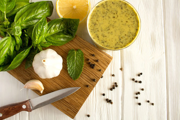 Ingredients and thai sauce  with  basil  and lemon on the  white  wooden background.Top view.