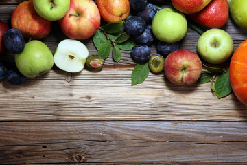 Various fresh fruits. Thanksgiving pumpkin, apples, and maize on rustic background.