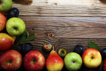 Various fresh fruits. Thanksgiving pumpkin, apples, and maize on rustic background.