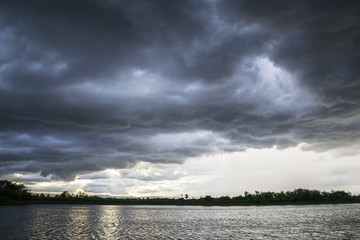 Fototapeta premium Light in the Dark and Dramatic Storm Clouds background