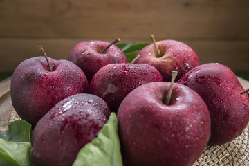 Fresh organic ripe apple fruits on old wooden table.
