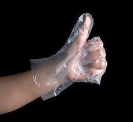Man hand wearing disposable plastic glove on black background