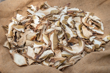 Dried porcini mushrooms on a wooden table.