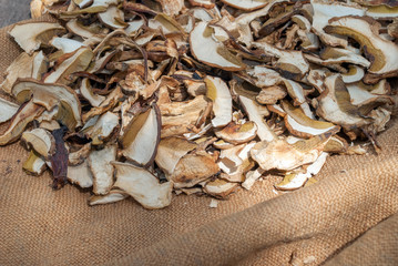Dried porcini mushrooms on a wooden table.