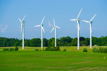 Windmill type wind electricity generator in the field in Latvia in summer
