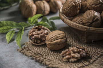 Walnuts in wooden bowl. Whole walnut on table