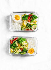 Vegetarian lunch box - stewed vegetables, rice and boiled egg on a light background, top view....