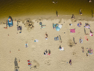 People enjoying the beach and swimming in the sea, aerial view