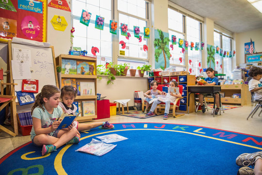 Students reading in a kindergarten classroom. 