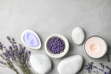 Flat lay composition with lavender flowers and natural cosmetic on grey background