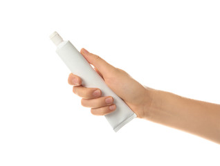 Woman holding toothpaste against white background. Dental care
