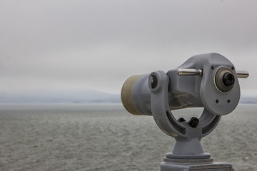 Coin Operated telescope viewer next to the waterside promenade looking out to the bay and city.