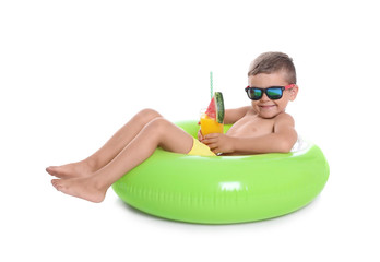 Fototapeta premium Cute little boy with inflatable ring and glass of cocktail on white background