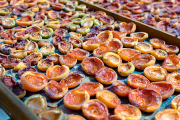 Homemade dried apricots. A leaf with halves of apricots