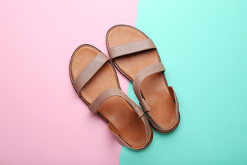 Female beige sandals on colorful background