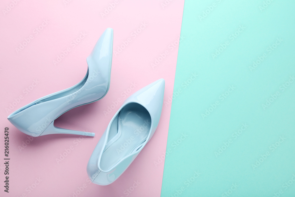 Wall mural blue high heel shoes on colorful background