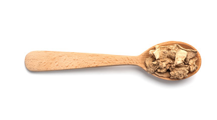 Wooden spoon with dried ginger on white background. Different spices