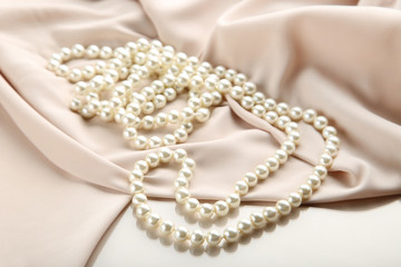 Pearl necklace with beige satin fabric