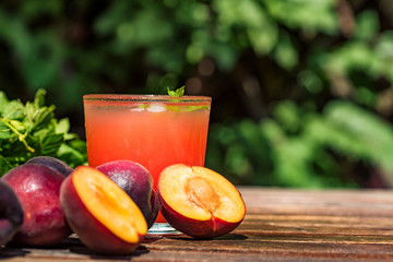 Fresh plum smoothie with plums close