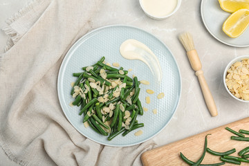 Tasty green beans with almonds served for dinner on table, top view