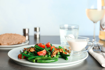 Plate of fresh green bean salad on table