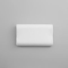 Clean soft orthopedic pillow on grey background, top view