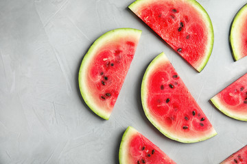 Flat lay composition with watermelon slices on grey background