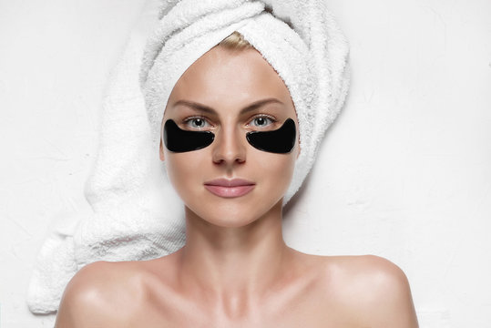 Cosmetic Mask For The Skin Under The Eyes. Patch Eye Mask On A Girl With A Towel On Her Head