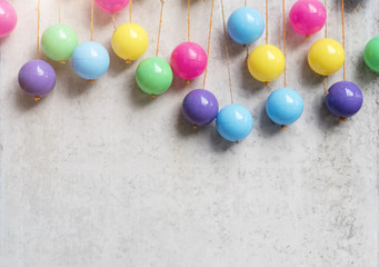 Abstract background from colorful balls hang on grey concrete wall. Party and celebrating backdrop. Picture for add text message. Backdrop for design art work.