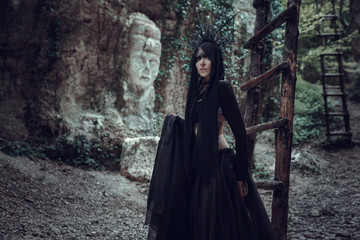 A woman is a prophet sorcerer and a preacher in a black mystical cloak