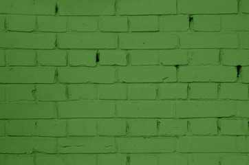 Brick wall of green painted brick. Green brick wall texture.