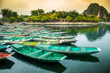 Naklejka na ściany i meble Amazing morning view with Vietnamese boats at river, Tam Coc, Ninh Binh in Vietnam travel landscape and destinations