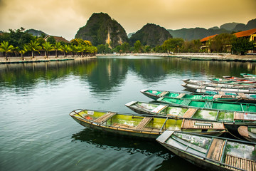 Amazing morning view with Vietnamese boats at river, Tam Coc, Ninh Binh in Vietnam travel landscape and destinations
