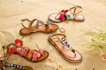Colorful Sandals with Sand Beach Background
