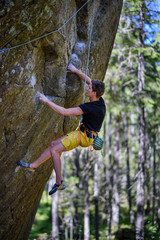 Young climber man climbing a rock.Active lifestyle concept.