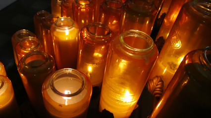 Candles burning in glass jars