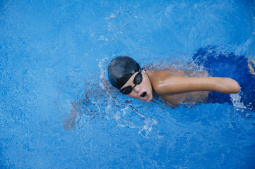 Young boy who does swimming and he lacks an arm, disabled person