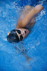 Young boy who does swimming and he lacks an arm, disabled person