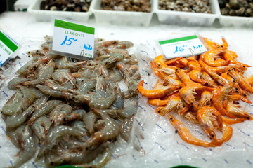 The counter on the market, seafood on ice, shrimps,prawns The Boqueria Market in Barcelona, Spain.