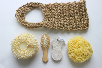 Spa accessories-sponge, natural soap, essential oil, pumice, salt, washcloth, comb, candles on a light background, top view. The concept of a healthy lifestyle. Beauty, skin care. flat position