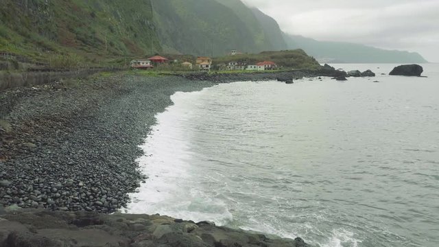 Up view of waves of ocean from cliffy shore of the north of Madeira