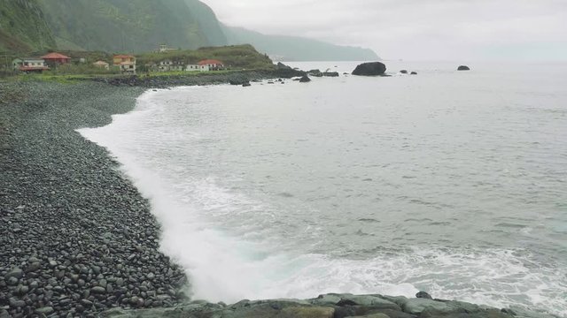 Up view of waves of ocean from cliffy shore of the north of Madeira