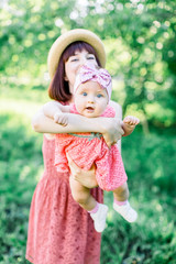 Outdoor Portrait of happy family. family look. Happy mother having fun with her daughter