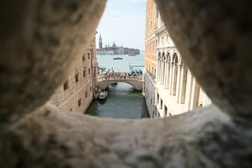 Fotobehang Brug der Zuchten Venice,Italy-July 25, 2018: View from a stone bar window of the Bridge of Sighs in Venice  