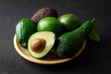 Fresh avocado fruit on a wooden plate. The concept of healthy eating. Food photography