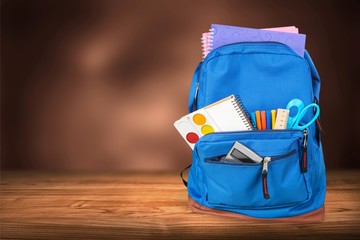 School bag on wooden desk