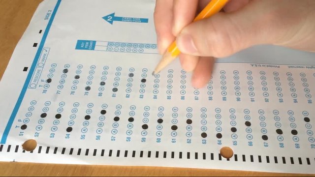 Student fills out bubbles in a standardized test form
