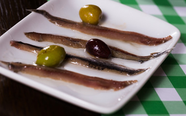 Image of plate with fish and olives